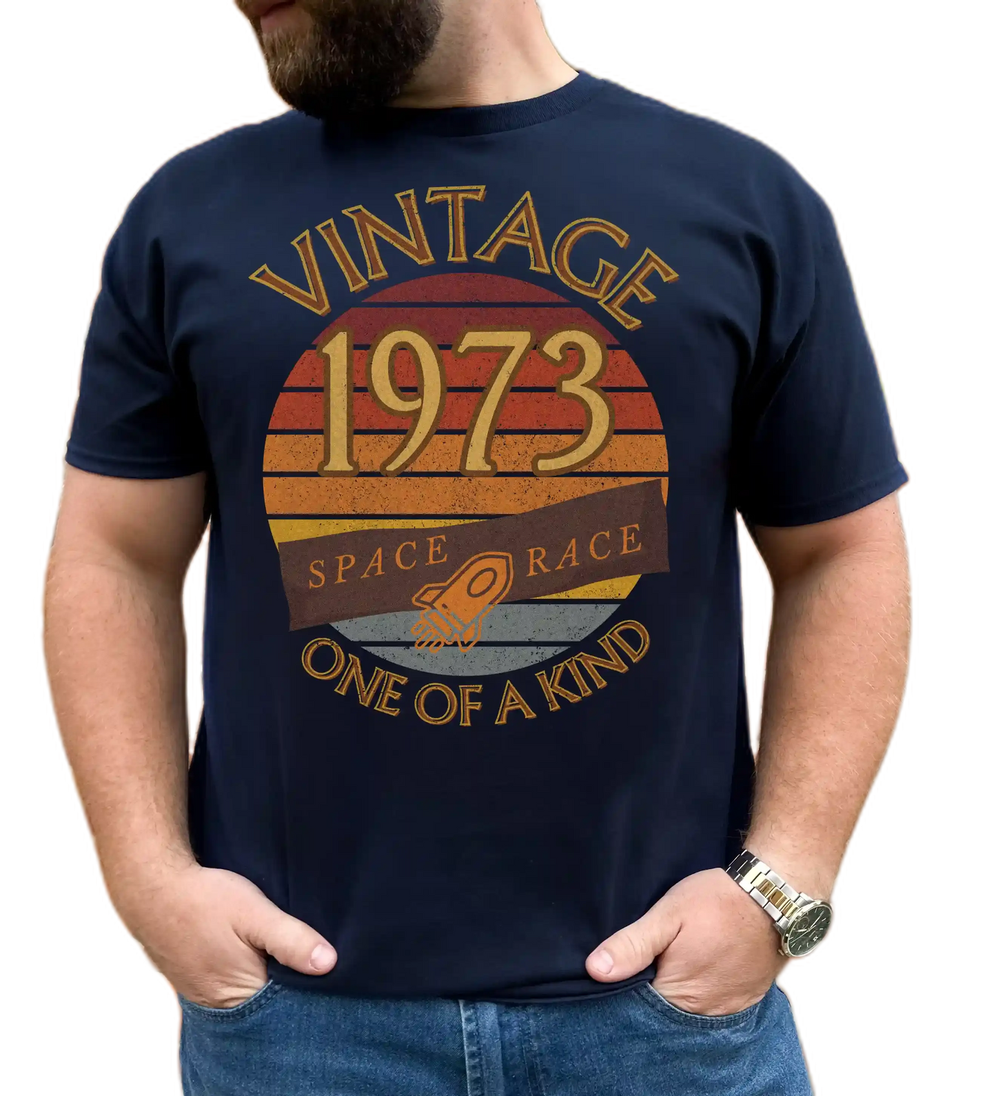 A man wearing a navy T-Shirt with words vintage,1973,space race,one of a kind, image of a simple rocket in front of a brown distressed sunset