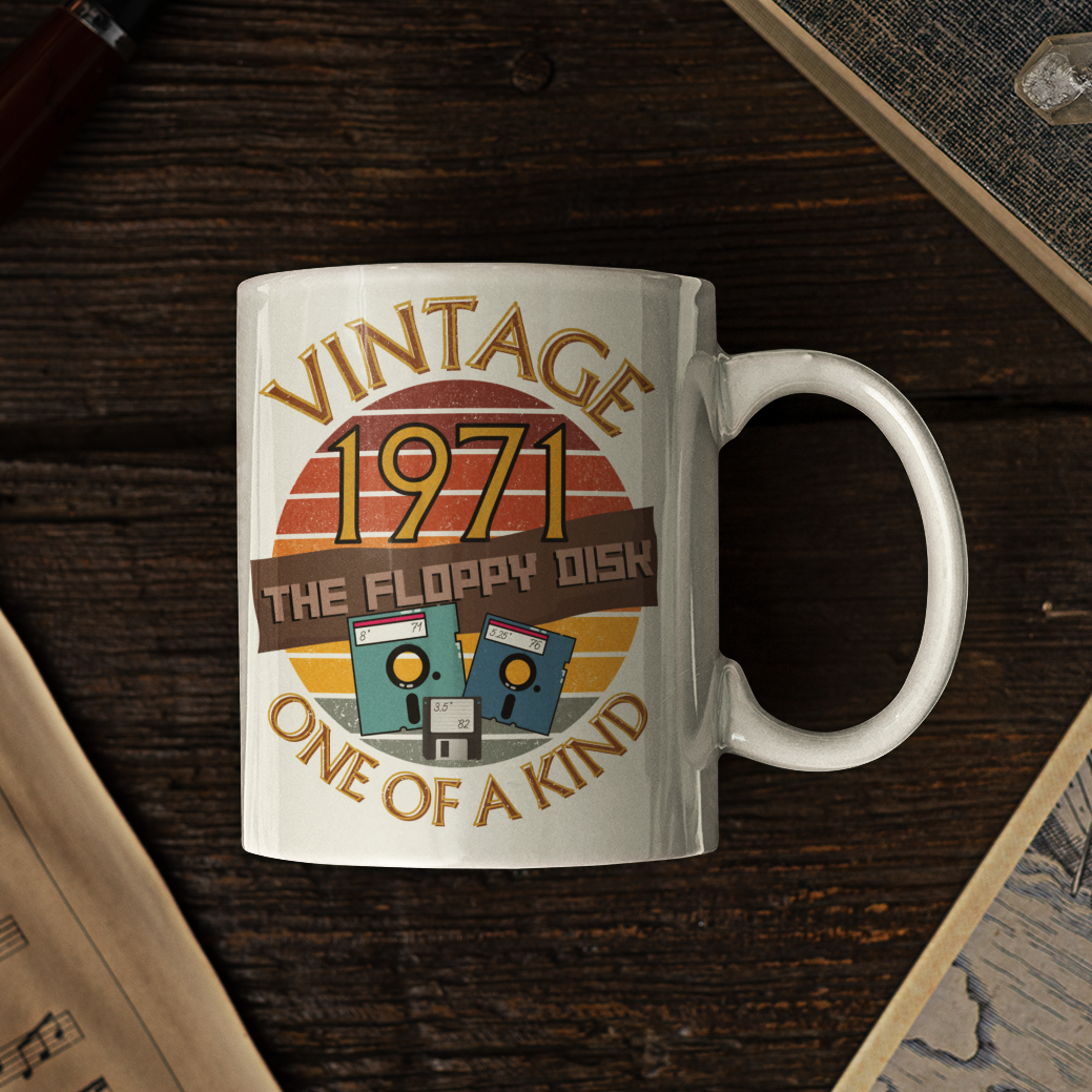 White mug with the words vintage,1971,the floppy disk ,one of a kind, 3 different types of floppy disk,8,5.25,3.5 inch