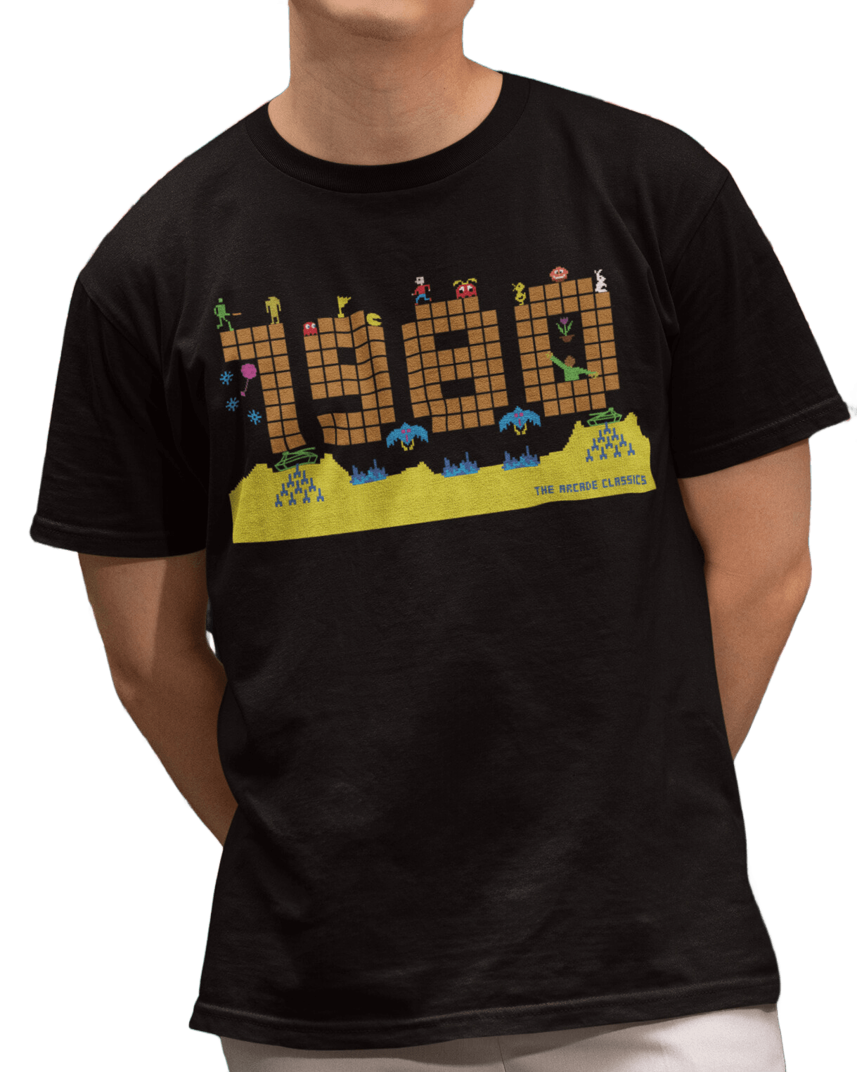 Black t shirt with a large 1980 in pixels in orange brown with some notable arcade video gaming sprites from 1980 around it