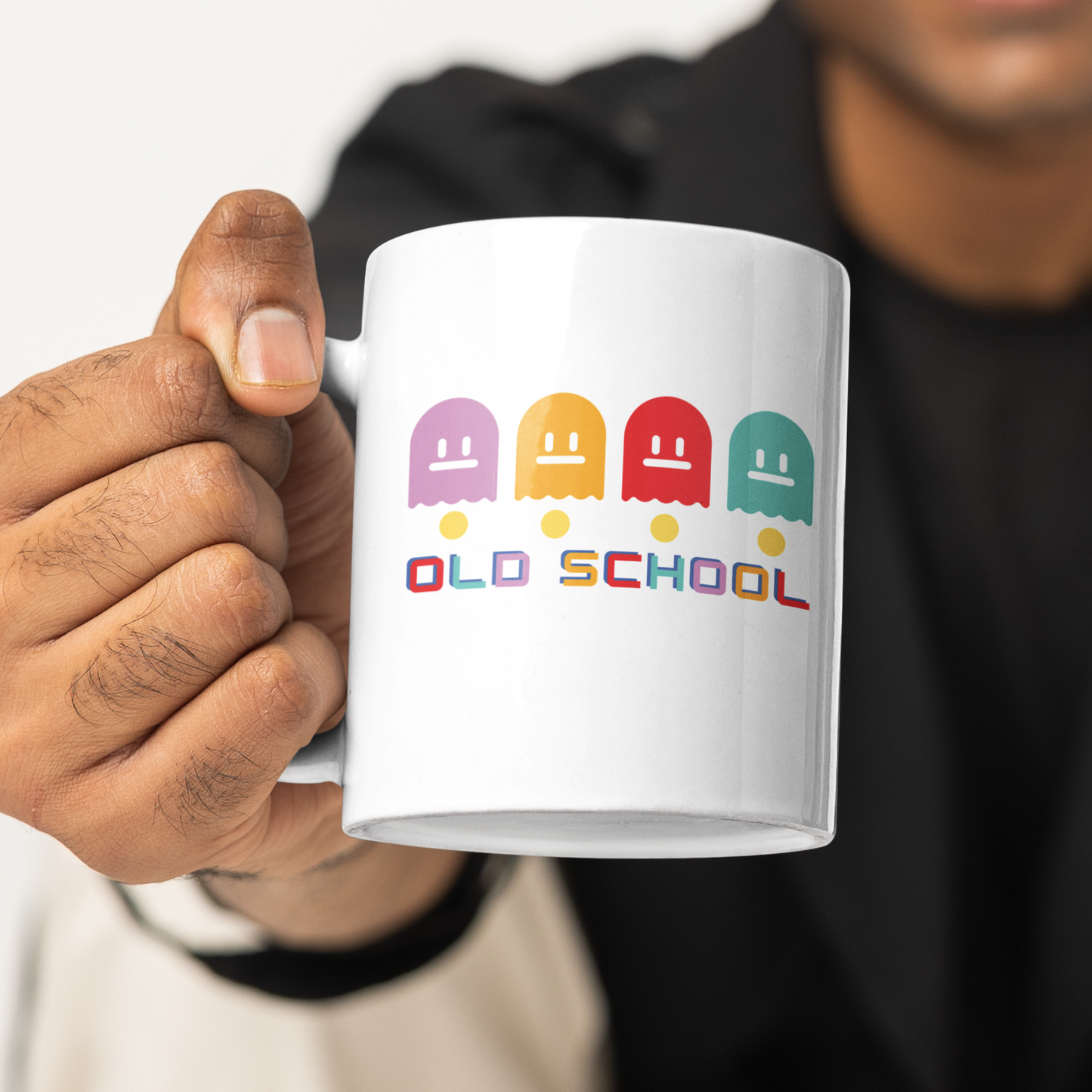 White mug with multicoloured ghost characters , over yellow pac man dots and old school in different colours for each letter