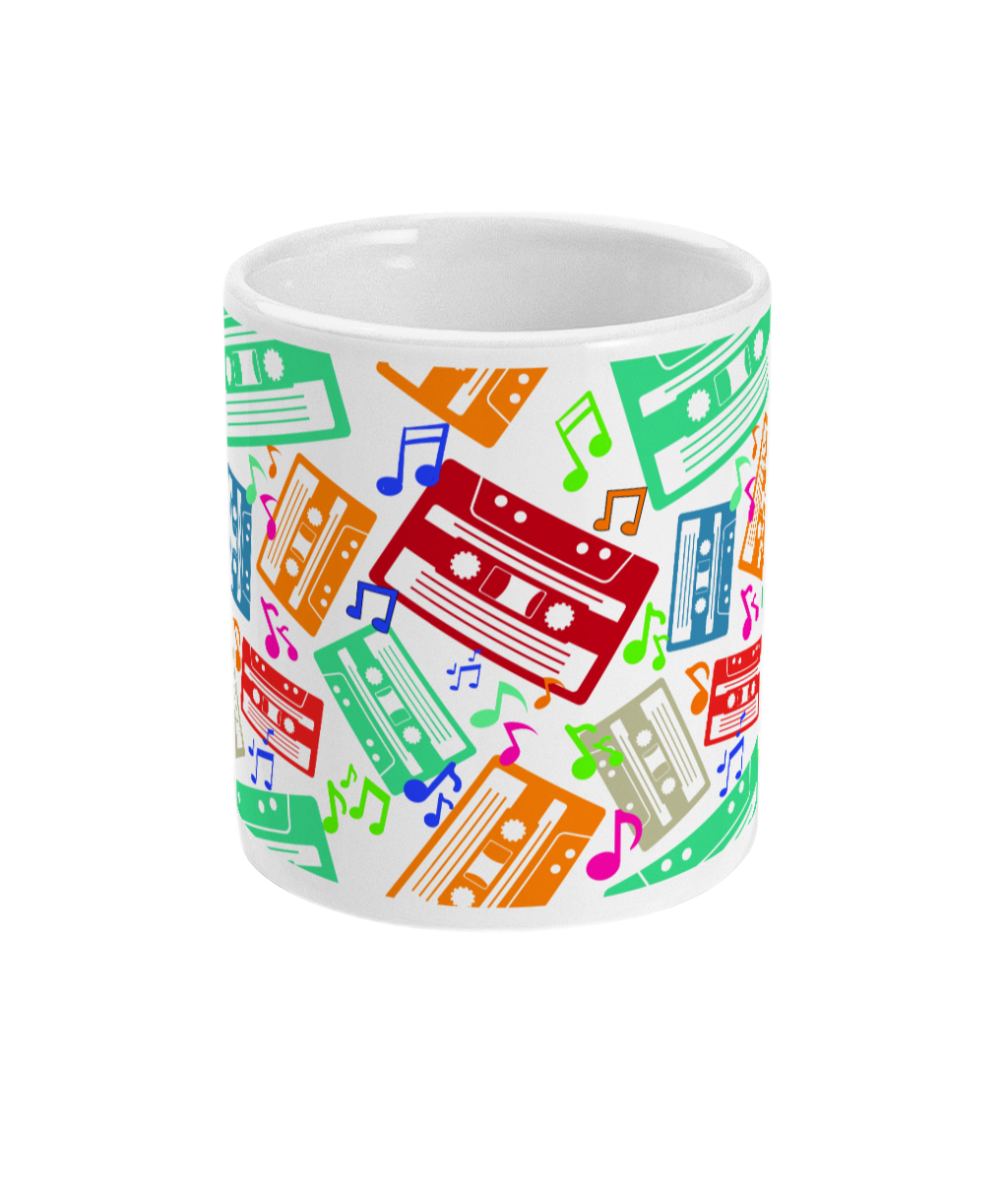 White mug with colourful music notes and cassette tapes spread out at different angles in different colours around the sides and front.