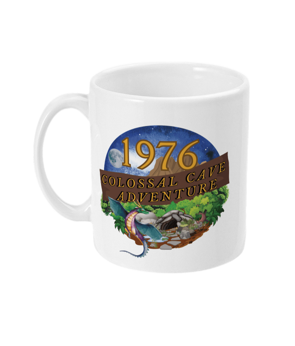 White mug with words,1976,colossal cave adventure,circular picture of a dragon,cave and woodland,night sky