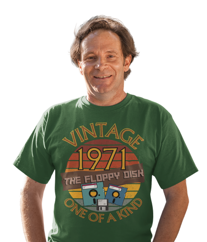 A man wearing a green T-Shirt with the words vintage,1971,the floppy disk ,one of a kind, 3 different types of floppy disk,8,5.25,3.5 inch