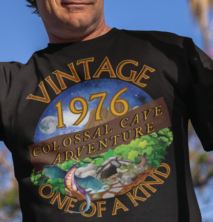 A man wearing a black T-Shirt with words vintage,1976,colossal cave adventure,one of a kind,circular picture of a dragon,cave and woodland,night sky