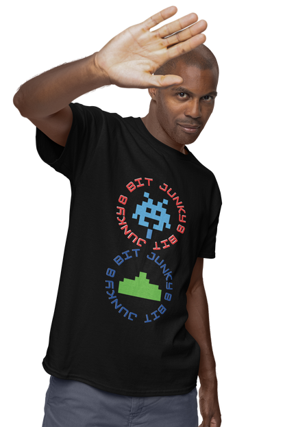 A man wearing a black T-Shirt with words 8-bit junky in 2 circles making a figure 8 with an invader in one circle and earth ship in the other