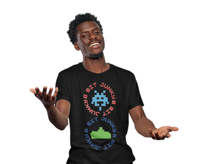 A man wearing a black T-Shirt with words 8-bit junky in 2 circles making a figure 8 with an invader in one circle and earth ship in the other