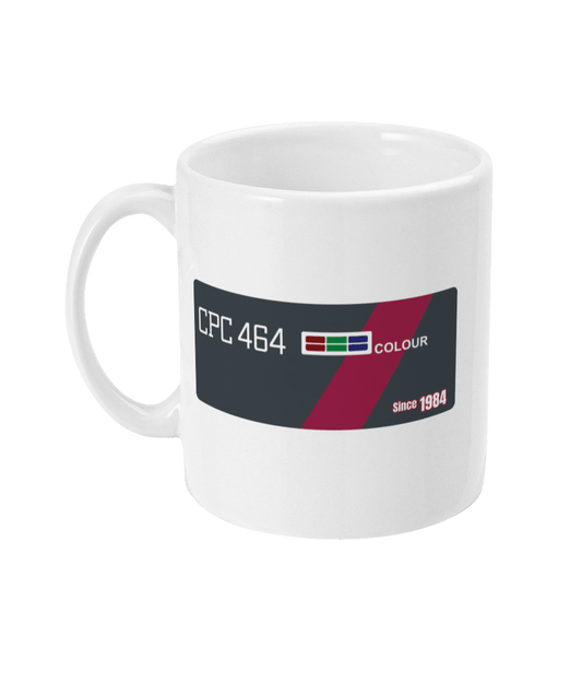 White mug echoing the original Amstrad CPC 464 computer bezel. Features ‘CPC 464’ in bold white text on the left, an RGB color bar, and the word ‘COLOUR’, diagonally across a maroon stripe—mirroring the machine’s iconic styling. A small label on the right reads ‘Since 1984’, celebrating the computer’s launch year and legac