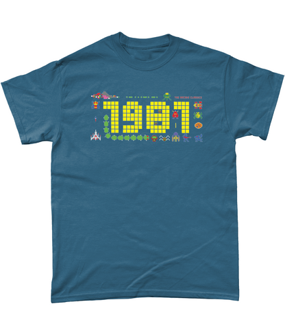 Indigo  t shirt with a large 1981 in pixels in yellow with some notable arcade video gaming sprites from 1981 around it