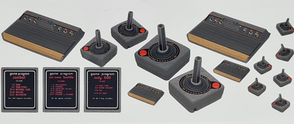 The Atari 2600 console with joysticks, game cartridges Combat, Indy 500 and Air Sea Battle carts.
