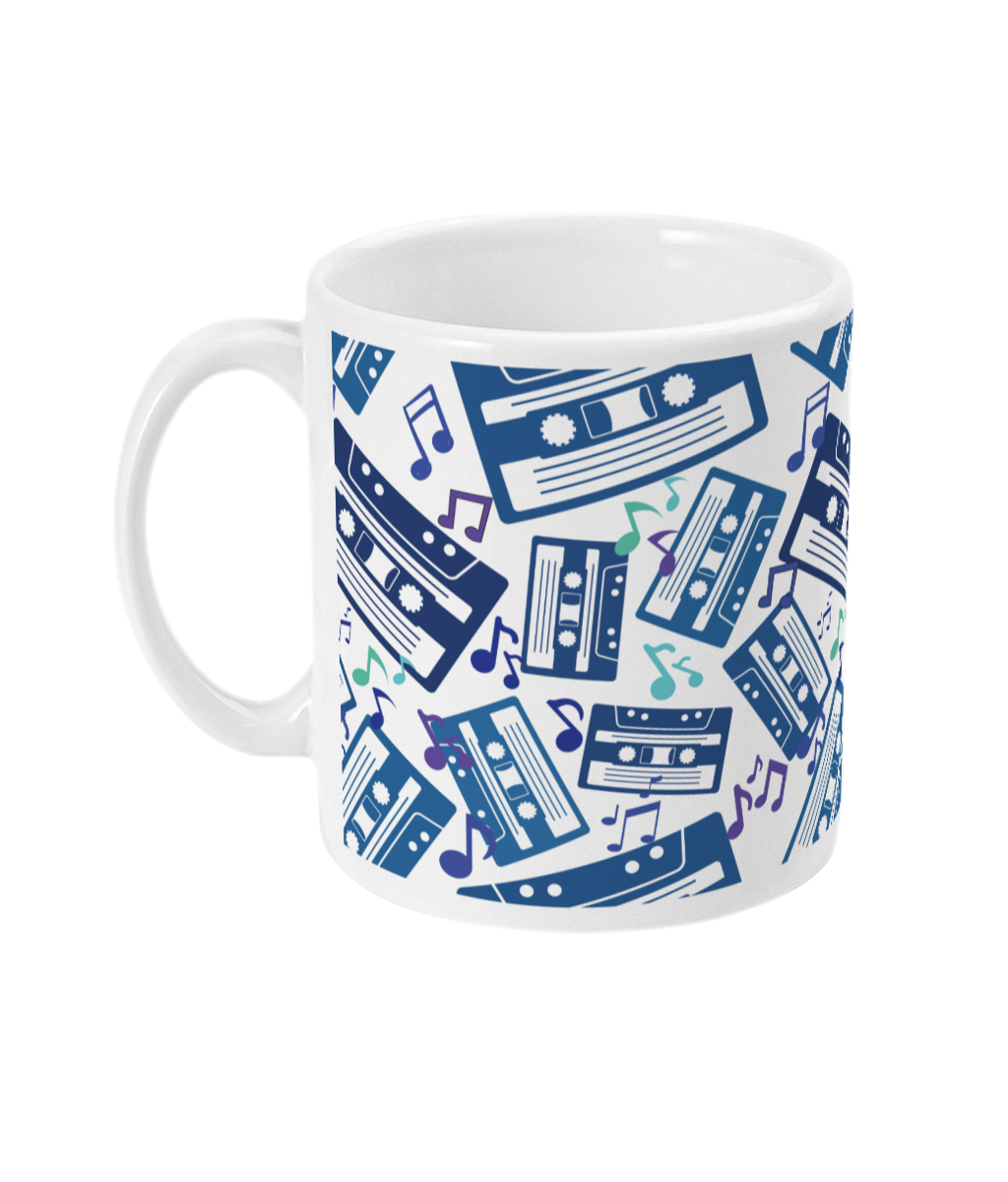 White mug with blue toned and purple music notes and cassette tapes spread out at different angles in different shades of blue around the sides and front.