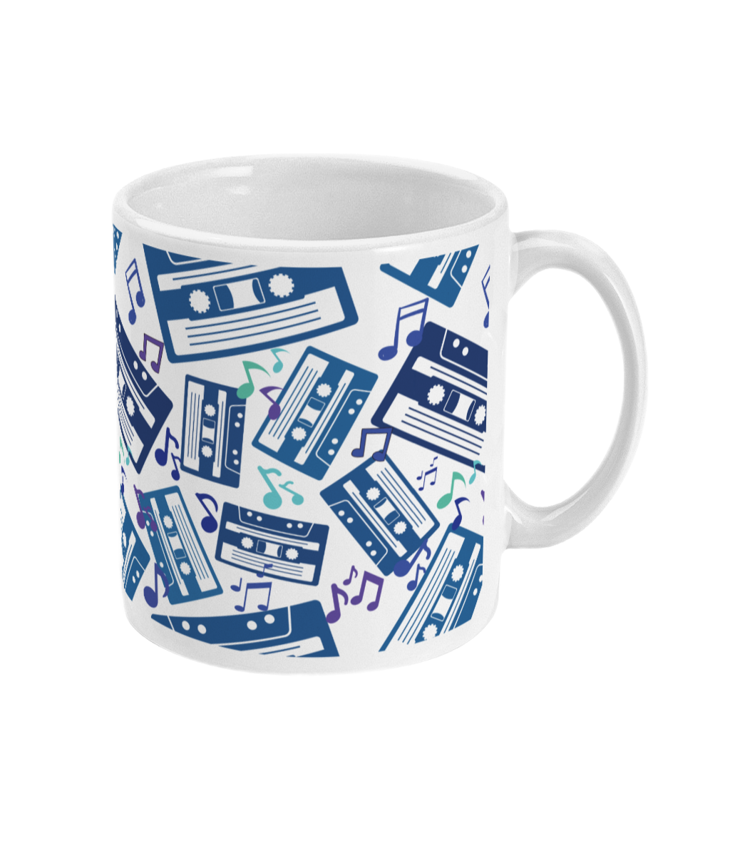White mug with blue toned and purple music notes and cassette tapes spread out at different angles in different shades of blue around the sides and front.