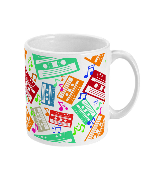 White mug with colourful music notes and cassette tapes spread out at different angles in different colours  around the sides and front.