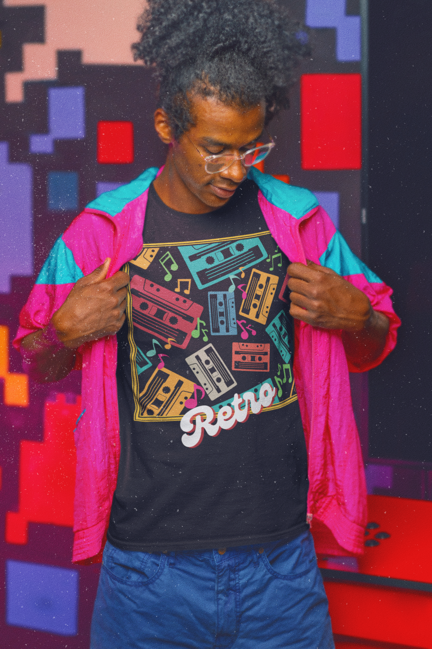 Model wearing black  T-Shirt  goldish square frame with colourful music notes and cassette tapes spread out at different angles in different colours ,words retro in a retro style at bottom 