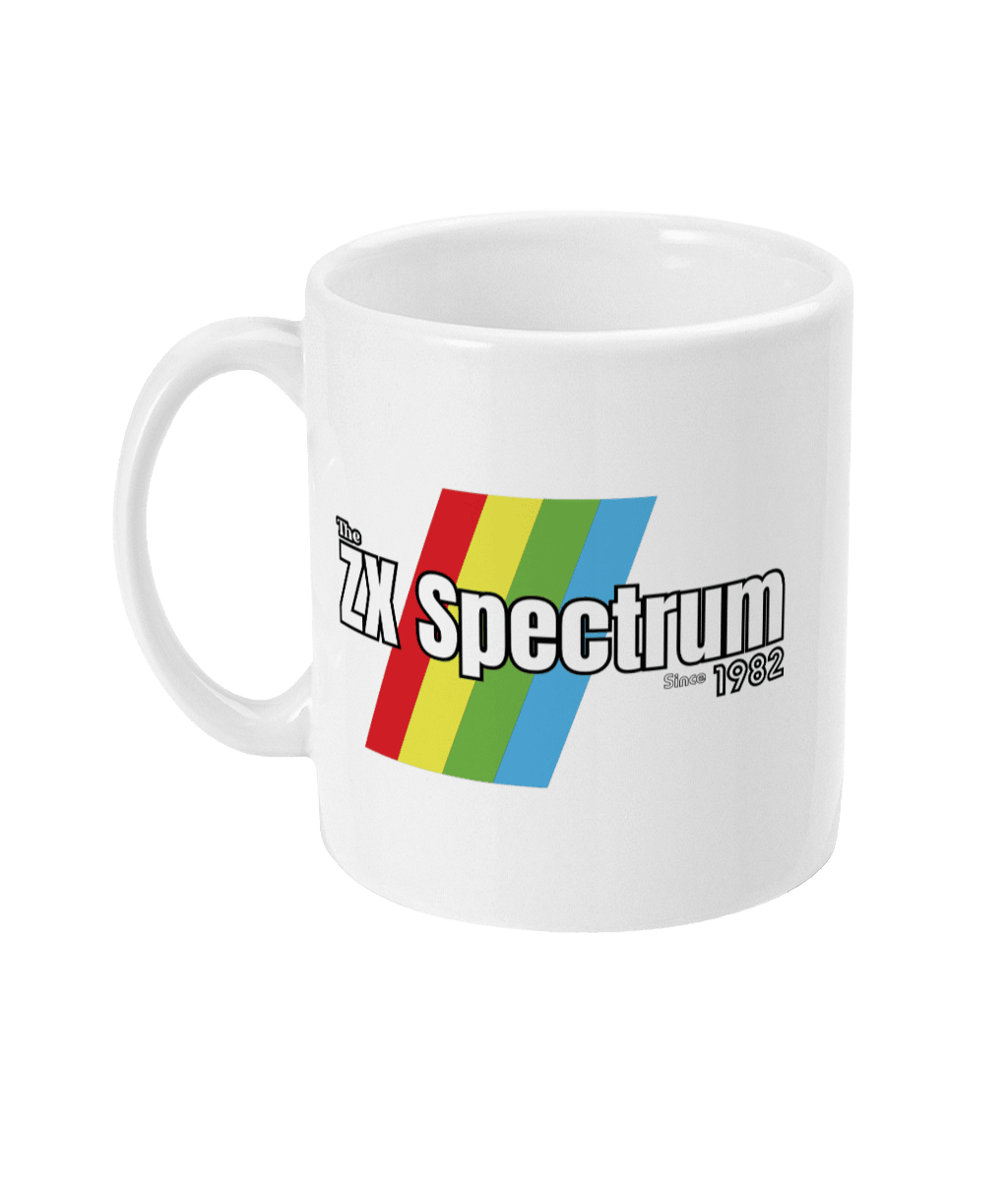 White mug featuring a retro design with the text " ZX Spectrum”  and text  “Since1982" in white with a black border  . Diagonal rainbow stripes in red, yellow, green, and blue run behind and evoke the iconic Sinclair ZX Spectrum branding.