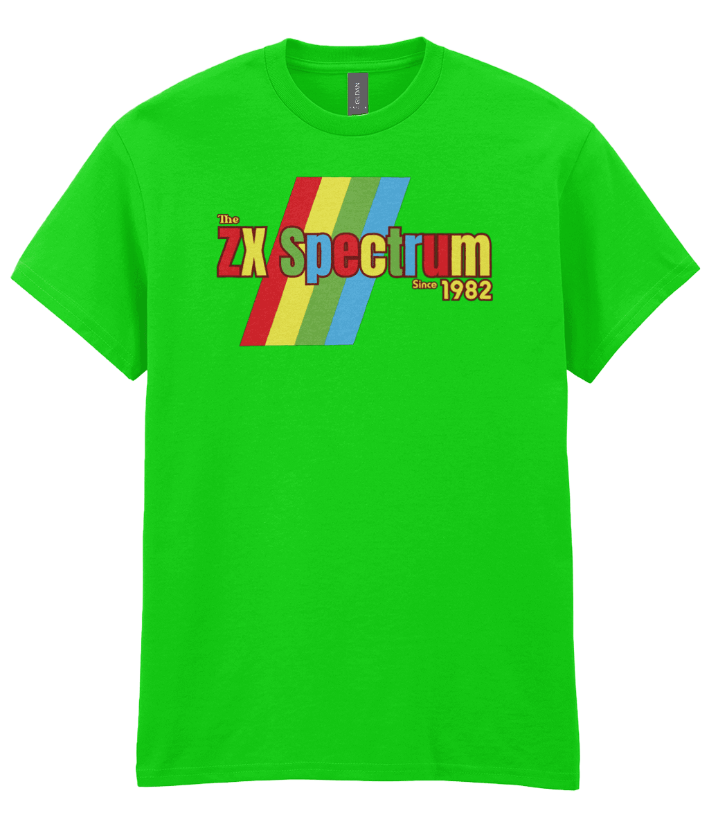 Antique Irish Green T-shirt featuring a retro design with the text "The ZX Spectrum" in bold, stylized font. The word "Spectrum" appears in a red-to-yellow gradient, with "Since 1982" in small yellow text below. Four diagonal rainbow stripes—red, yellow, blue, and light blue—run behind the text, referencing the iconic Sinclair ZX Spectrum branding. The shirt pays homage to the 1982 British home computer that sparked playground rivalries and a generation of 8-bit creativity.
