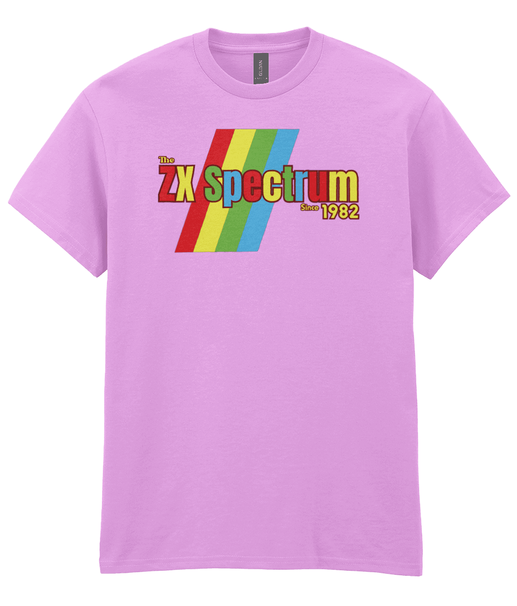 Light pink T-shirt featuring a retro design with the text "The ZX Spectrum" in bold, stylized font. The word "Spectrum" appears in a red-to-yellow gradient, with "Since 1982" in small yellow text below. Four diagonal rainbow stripes—red, yellow, blue, and light blue—run behind the text, referencing the iconic Sinclair ZX Spectrum branding. The shirt pays homage to the 1982 British home computer that sparked playground rivalries and a generation of 8-bit creativity.
