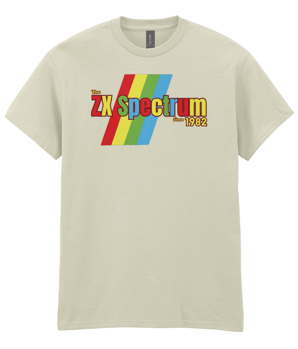 Natural T-shirt featuring a retro design with the text "The ZX Spectrum" in bold, stylized font. The word "Spectrum" appears in a red-to-yellow gradient, with "Since 1982" in small yellow text below. Four diagonal rainbow stripes—red, yellow, blue, and light blue—run behind the text, referencing the iconic Sinclair ZX Spectrum branding. The shirt pays homage to the 1982 British home computer that sparked playground rivalries and a generation of 8-bit creativity.
