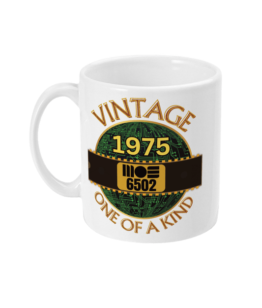 White mug with a gold circle with a basic representation of a circuit board in green and a 40 pin chip across the front with MOS 6502 and 1975 written on it. Vintage one of a kind around the circle
