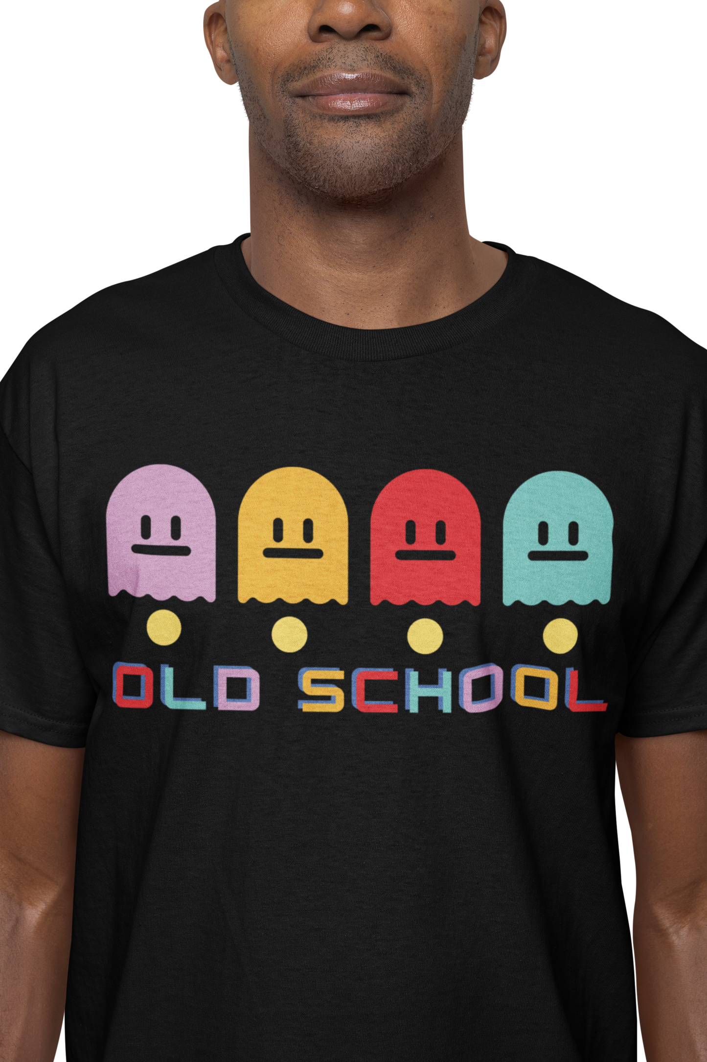 A man wearing a black T-Shirt with multicoloured ghost characters , over yellow pac man dots and old school in different colours for each letter  