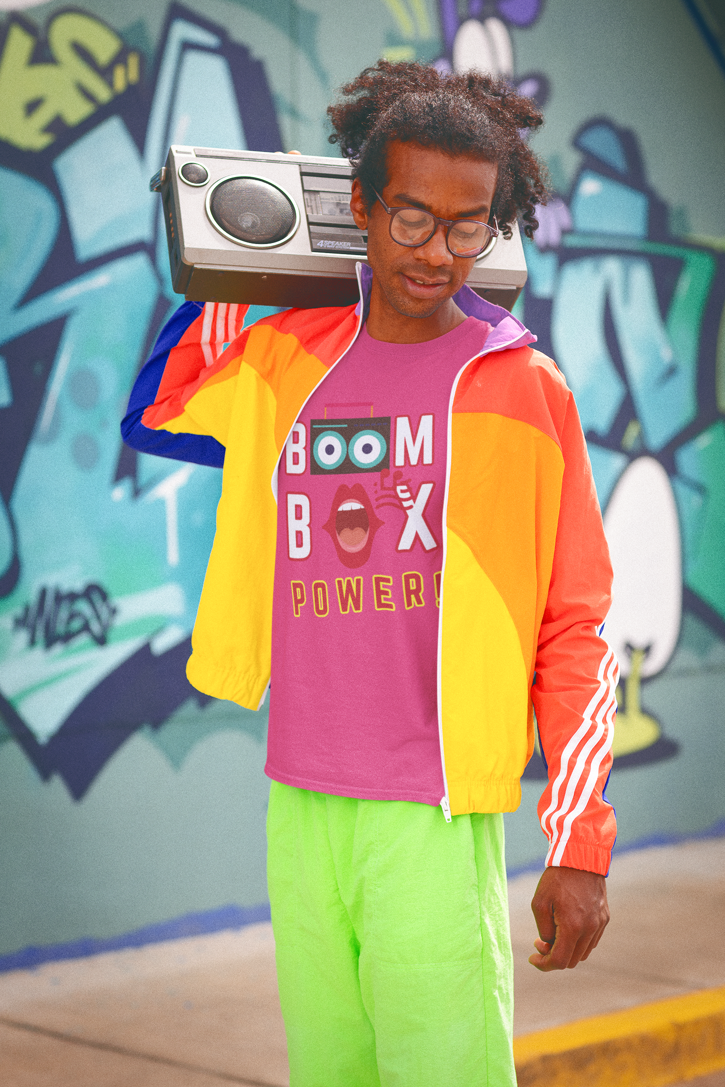 A man wearing a heliconia T-Shirt says BOOM BOX POWER! A boombox, the speakers make the Os in the word BOOM, a mouth indicating its singing as the O in BOX