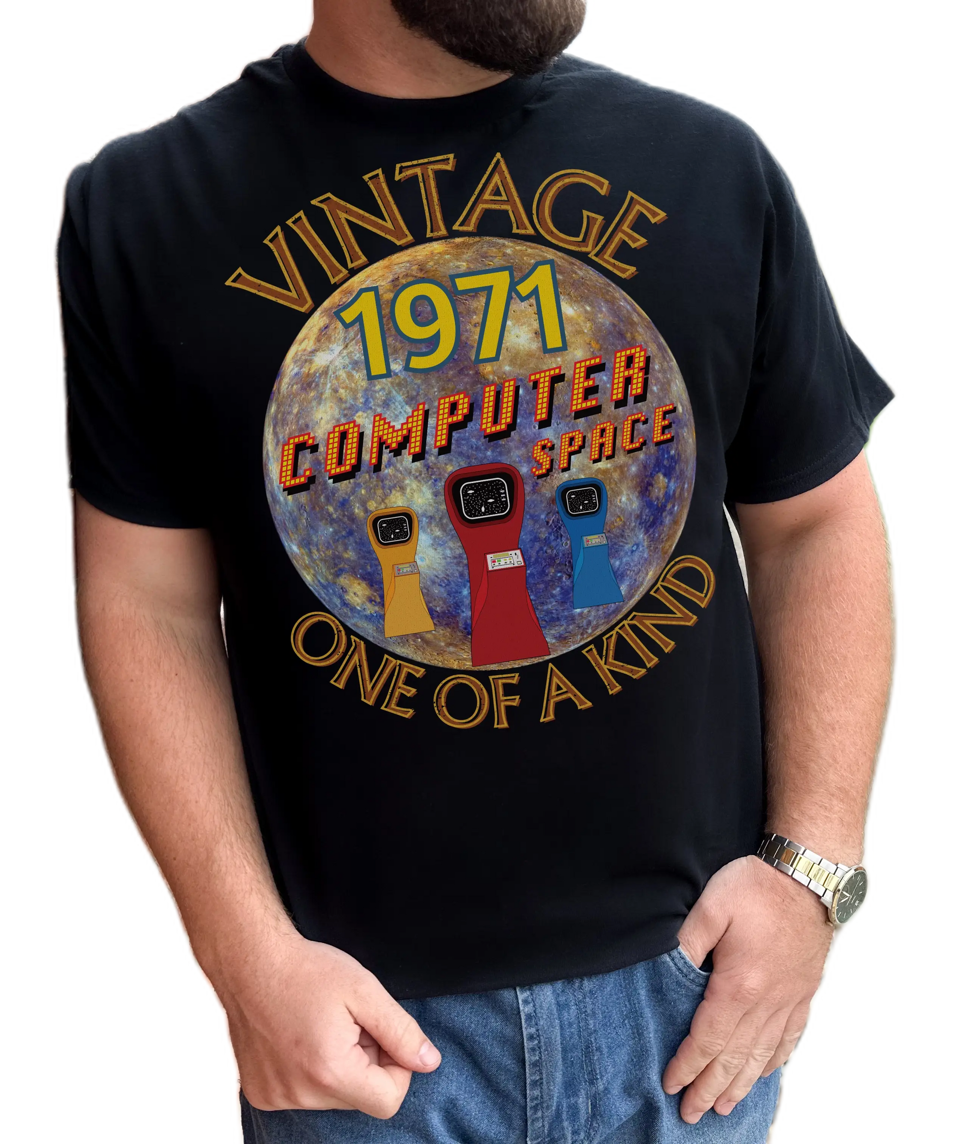 A man wearing black T-Shirt with the words vintage,1971,computer space,one of a kind,large earth, 3 computer space arcade machines