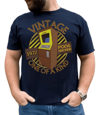 A man wearing a navy T-Shirt with words vintage,1972,pong arcade,one of a kind, image of a pong arcade machine in front of a yellow striped circle