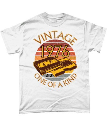 White T-Shirt with words vintage,1976,japan,one of a kind, image of a simple VHS tape in front of a brown distressed sunset