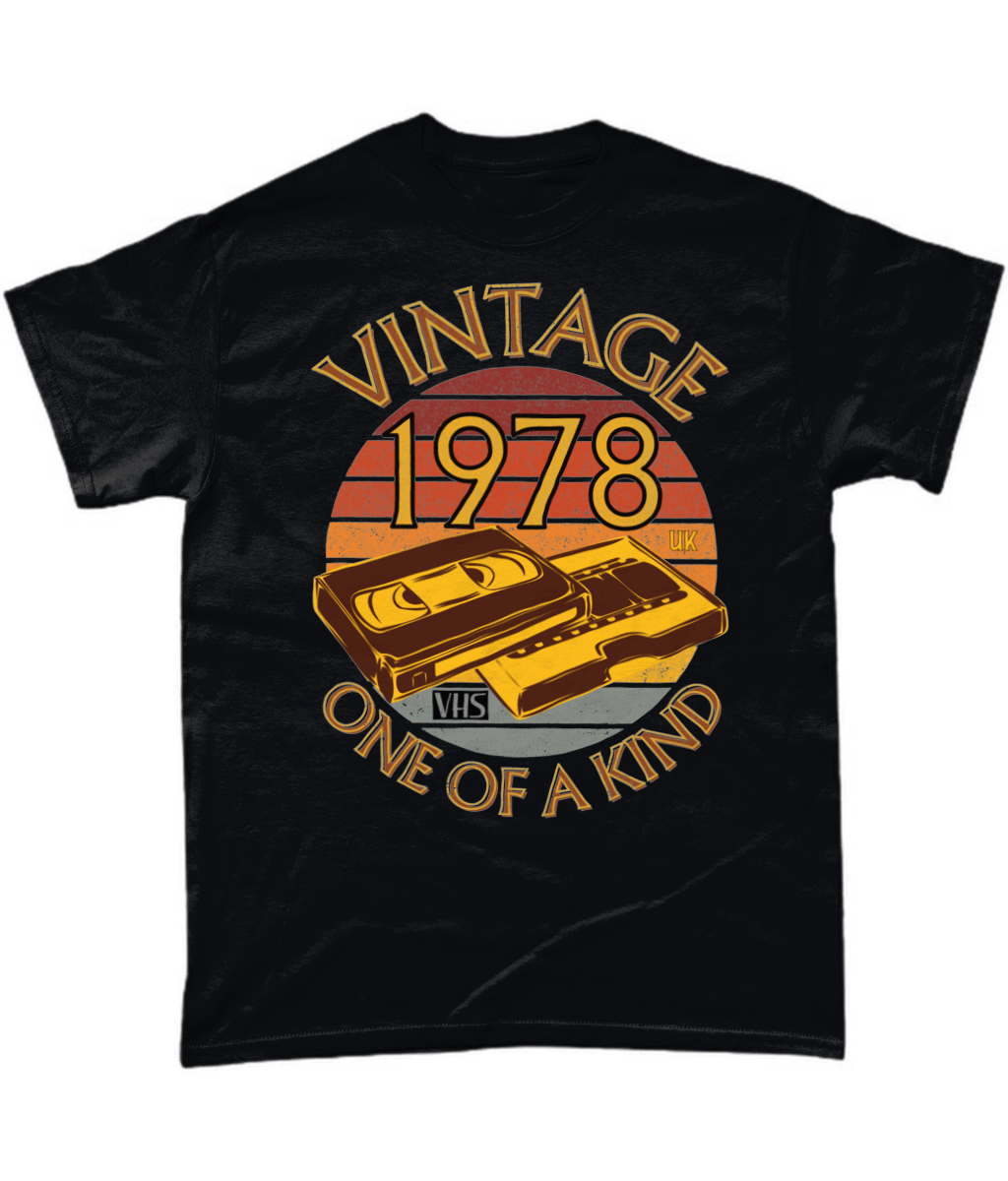 Black T-Shirt with words vintage,1978,uk,one of a kind, image of a simple VHS tape in front of a brown distressed sunset