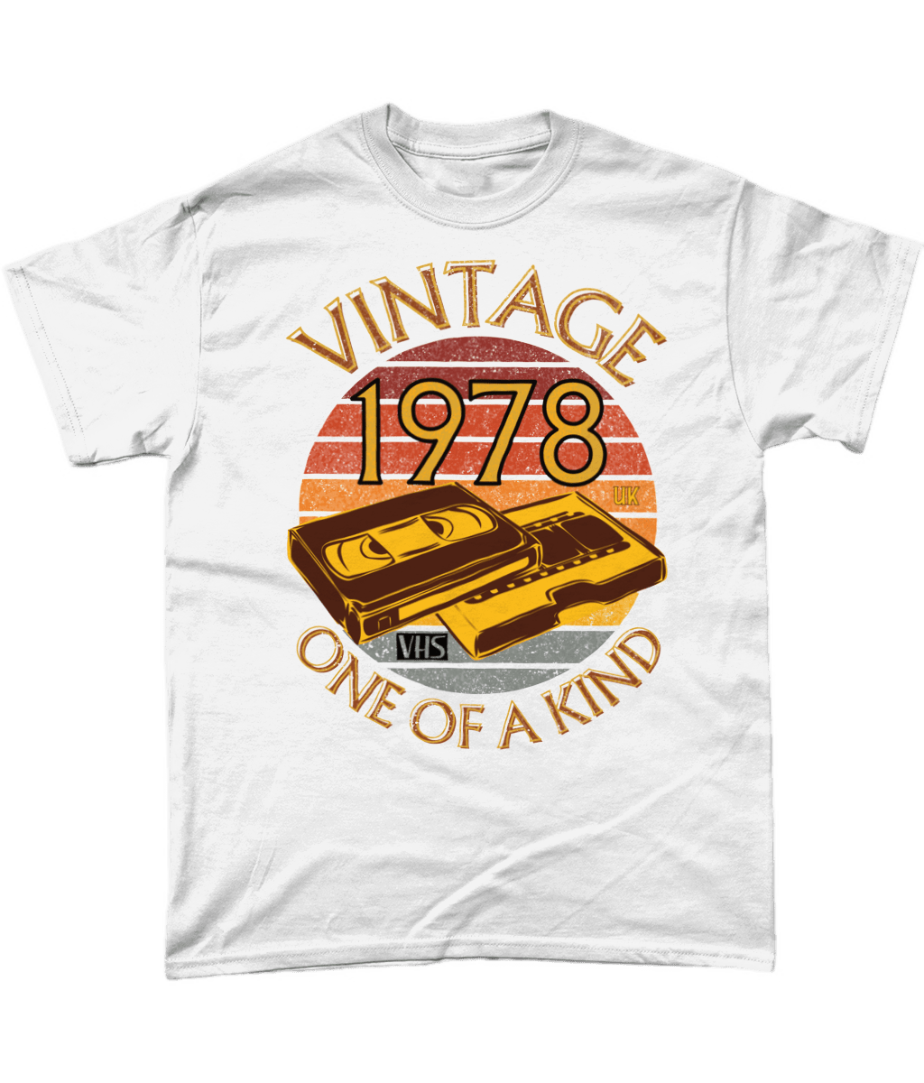White T-Shirt with words vintage,1978,uk,one of a kind, image of a simple VHS tape in front of a brown distressed sunset